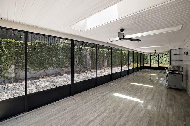 unfurnished sunroom featuring ceiling fan