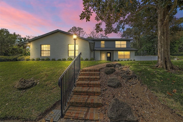 view of front of home with a lawn