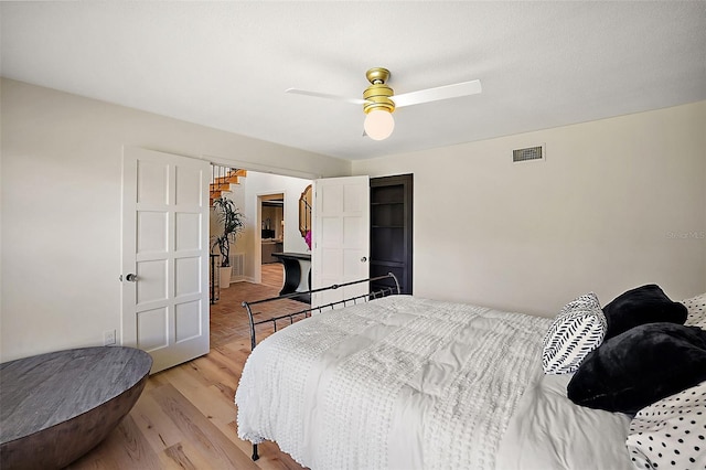 bedroom with light hardwood / wood-style flooring and ceiling fan