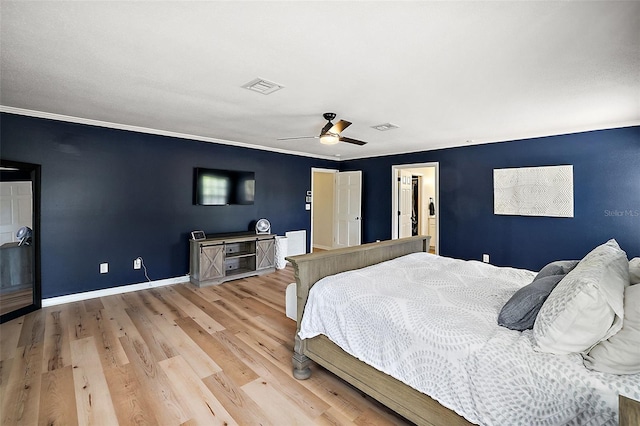 bedroom featuring ornamental molding, light hardwood / wood-style floors, and ceiling fan