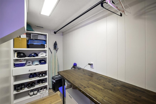 walk in closet with light wood-type flooring