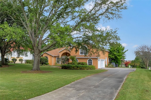 view of front of home with a front lawn and a garage