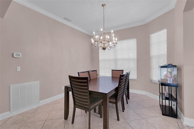 dining space with crown molding, light tile patterned floors, and a chandelier