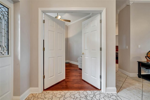 hall with ornamental molding and light hardwood / wood-style floors