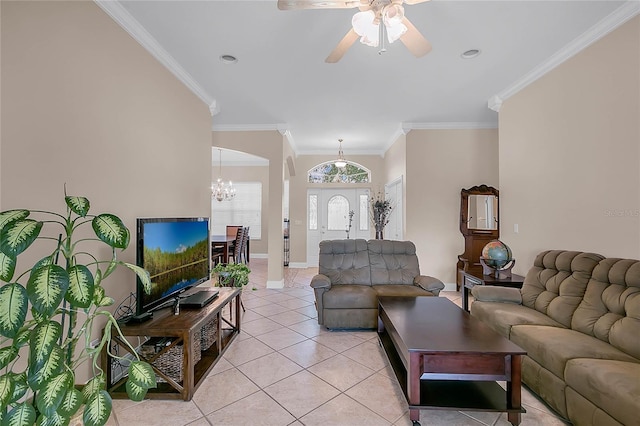 living room with ceiling fan with notable chandelier, light tile patterned floors, and crown molding