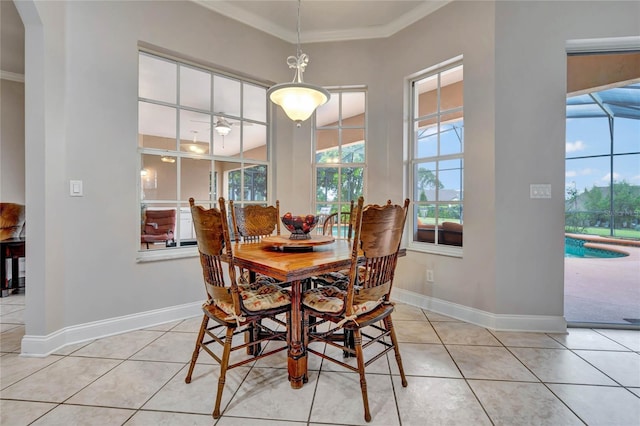 tiled dining space featuring ornamental molding, ceiling fan, and a healthy amount of sunlight