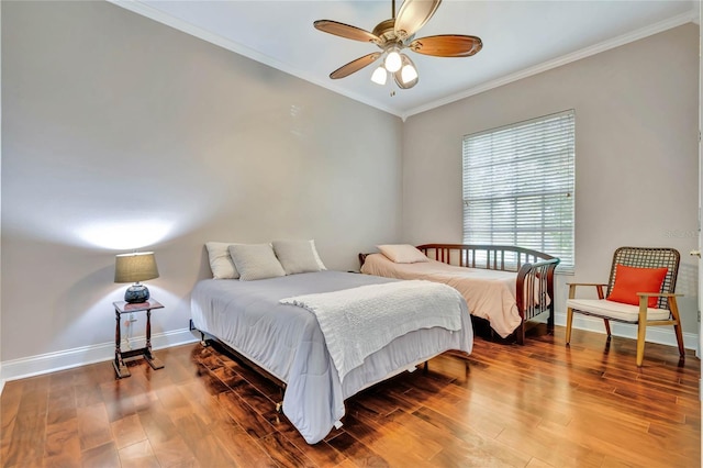 bedroom featuring ceiling fan, hardwood / wood-style flooring, and crown molding