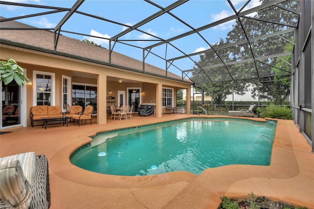 view of pool with a lanai, a patio, and pool water feature