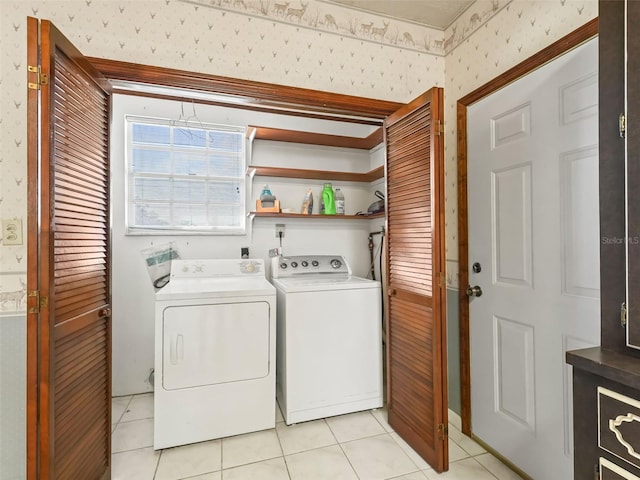 laundry area with washing machine and dryer and light tile floors