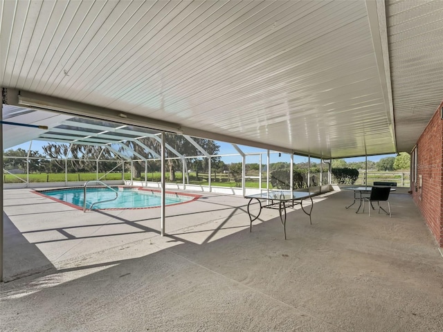 view of pool with a patio area and a lanai