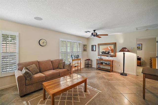 living room with tile floors, a textured ceiling, and ceiling fan