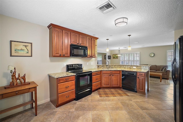 kitchen featuring black appliances, kitchen peninsula, decorative light fixtures, sink, and light tile flooring