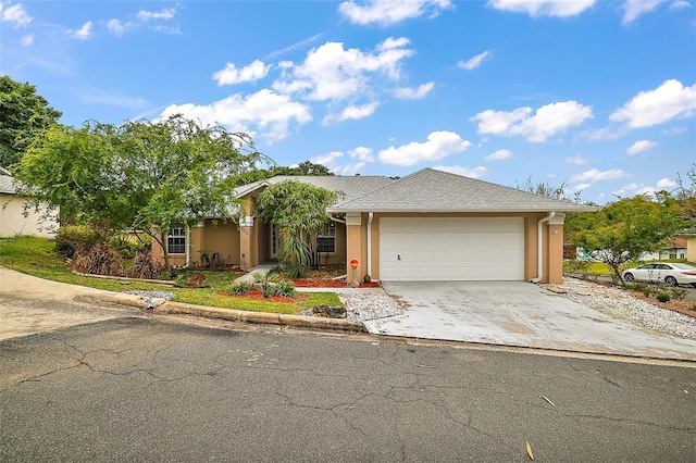 view of front of property featuring concrete driveway, an attached garage, and stucco siding