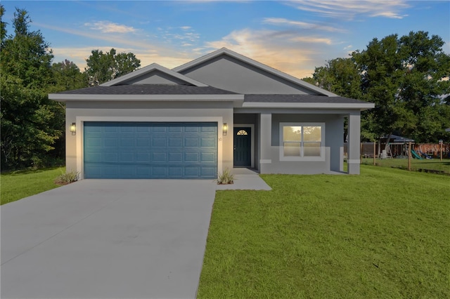 ranch-style home featuring a garage, a lawn, and a playground