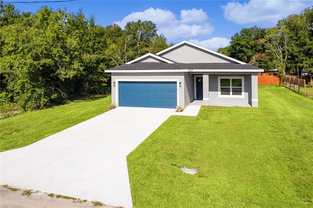 single story home featuring a garage and a front yard