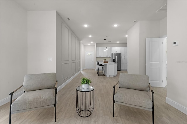 living area with light hardwood / wood-style floors