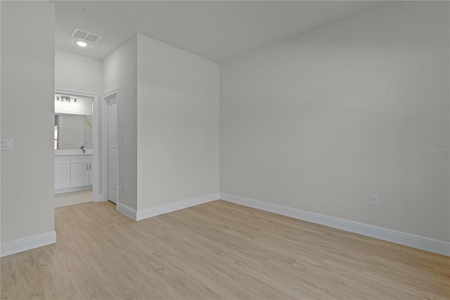 empty room with light hardwood / wood-style floors