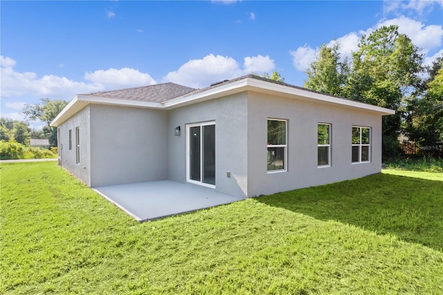 rear view of house featuring a patio area and a yard