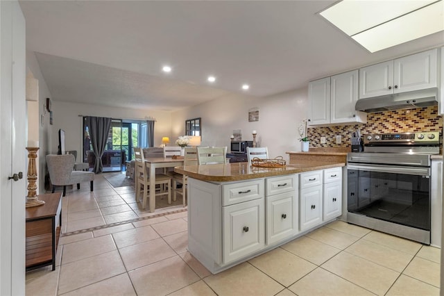 kitchen featuring white cabinetry, appliances with stainless steel finishes, light tile flooring, and kitchen peninsula