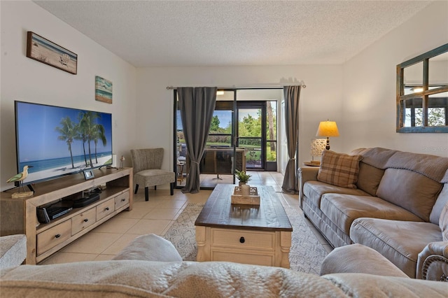 tiled living room featuring a textured ceiling