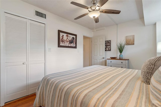 bedroom featuring a closet, ceiling fan, and light wood-type flooring