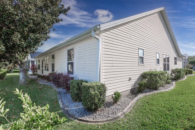 view of side of home featuring a yard