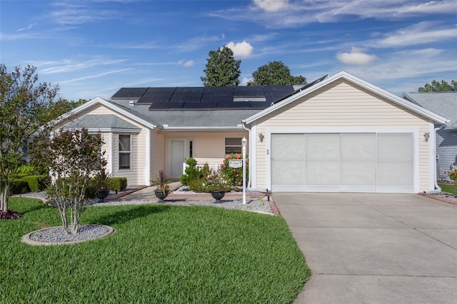 single story home featuring a front lawn, solar panels, and a garage