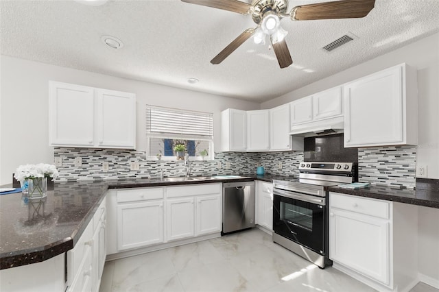 kitchen featuring decorative backsplash, stainless steel appliances, and white cabinetry