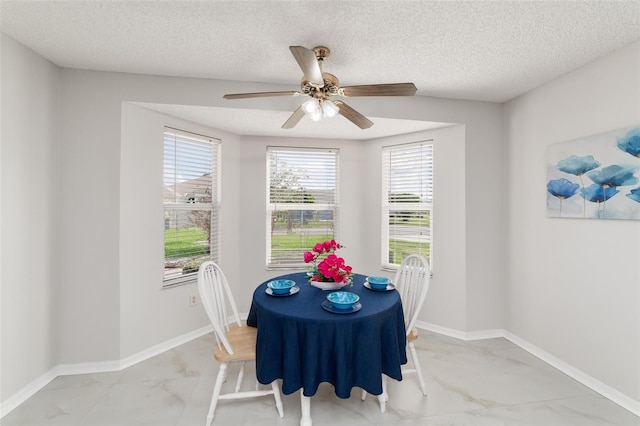 dining room featuring a textured ceiling and ceiling fan