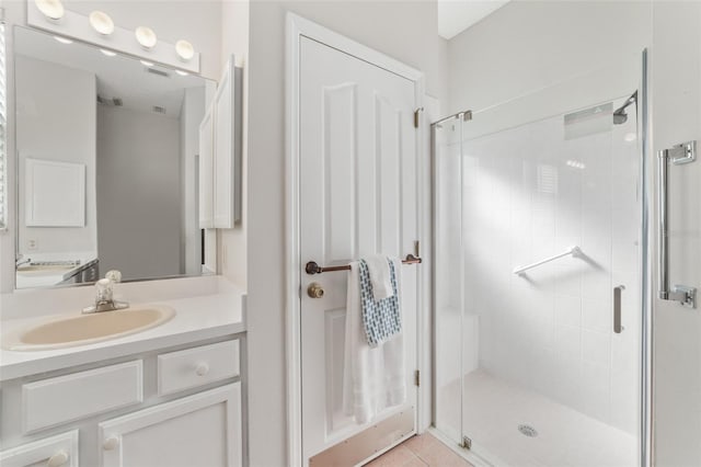 bathroom featuring vanity, tile patterned floors, and a shower with door