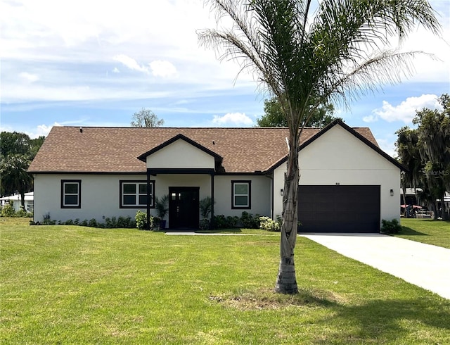 ranch-style home featuring a front lawn and a garage