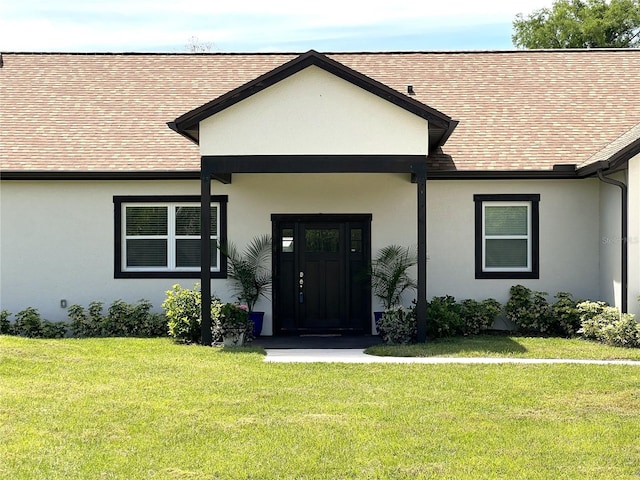 doorway to property with a lawn