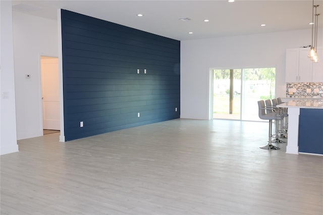 unfurnished living room with light hardwood / wood-style floors