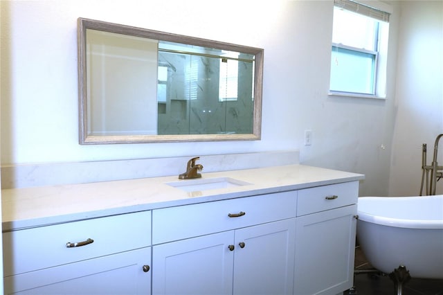 bathroom featuring oversized vanity and a bath to relax in