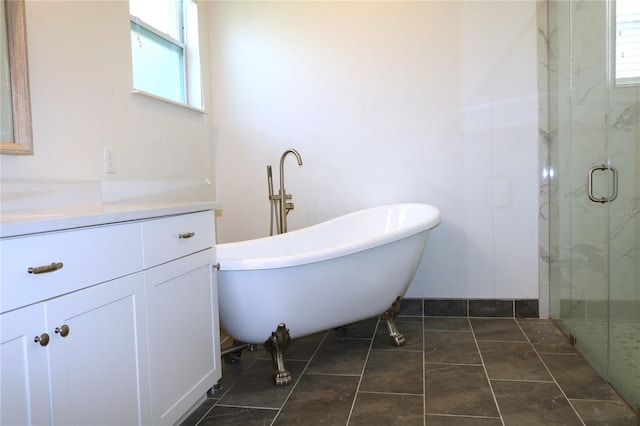 bathroom featuring walk in shower, a healthy amount of sunlight, tile floors, and vanity