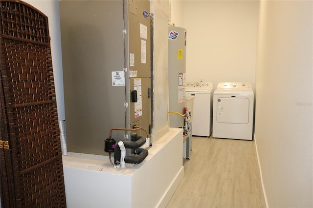 interior space with light hardwood / wood-style floors, washer and dryer, and gas water heater