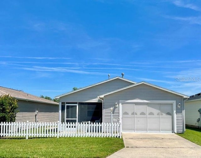 single story home with a garage, fence private yard, a front lawn, and concrete driveway