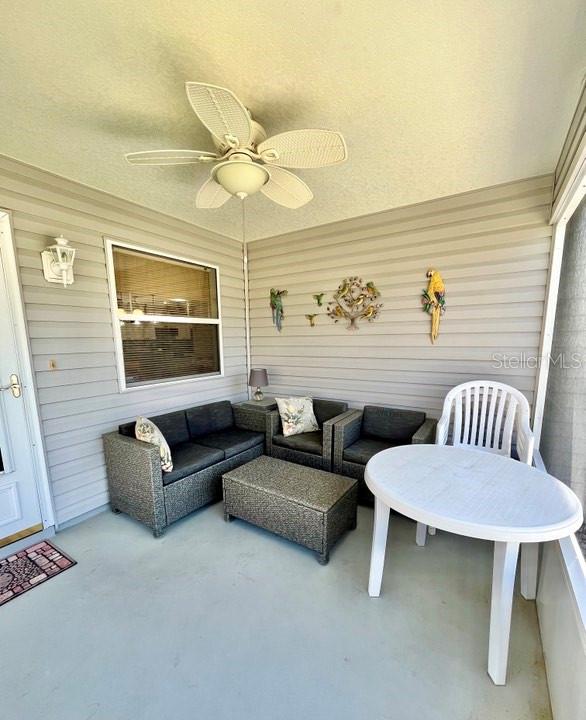 view of patio / terrace with ceiling fan and an outdoor living space