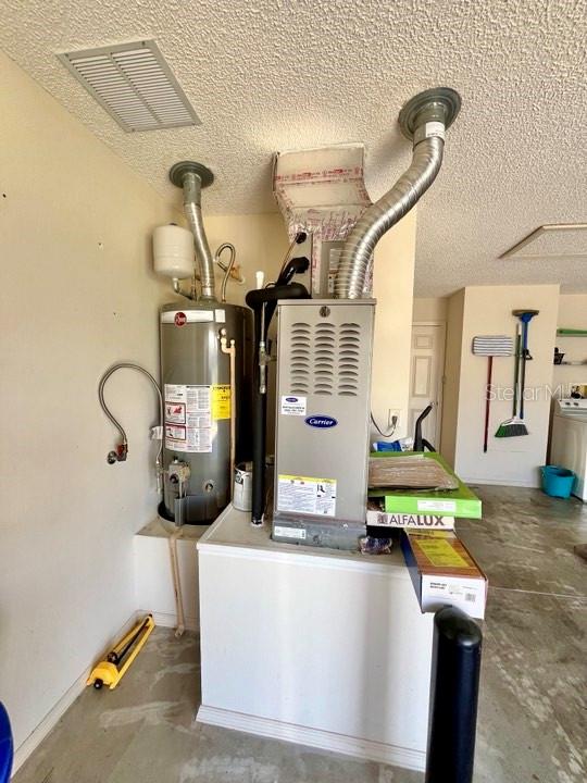 utility room with gas water heater