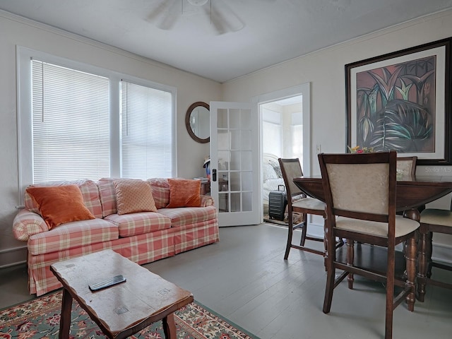 living room featuring french doors, light hardwood / wood-style floors, ornamental molding, and ceiling fan