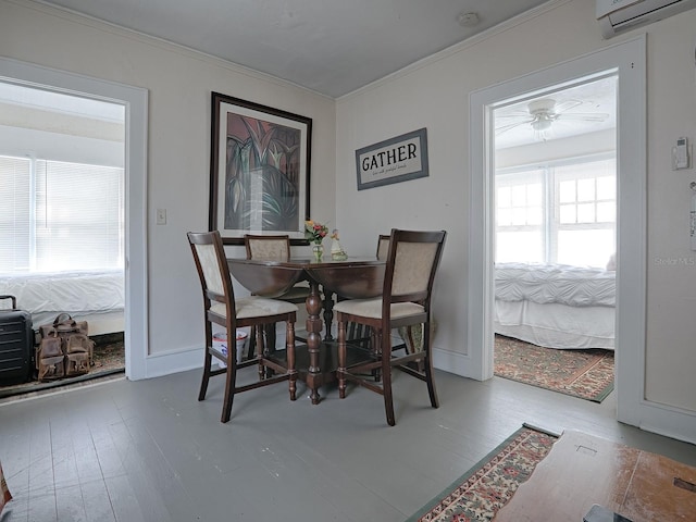 dining room with a wall mounted air conditioner, hardwood / wood-style floors, ornamental molding, and ceiling fan