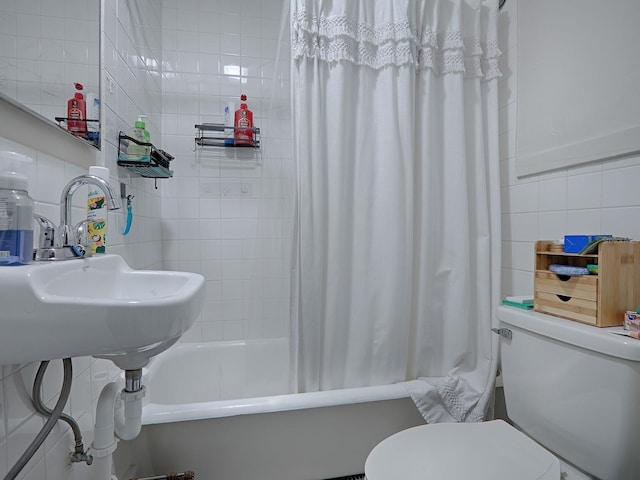 bathroom featuring shower / bath combo, toilet, and tile walls