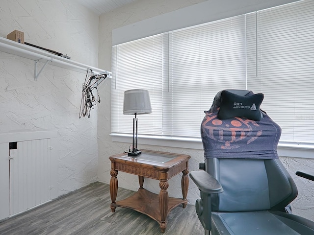 living area featuring plenty of natural light and hardwood / wood-style flooring