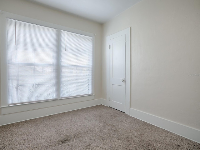 unfurnished room featuring light carpet and a healthy amount of sunlight