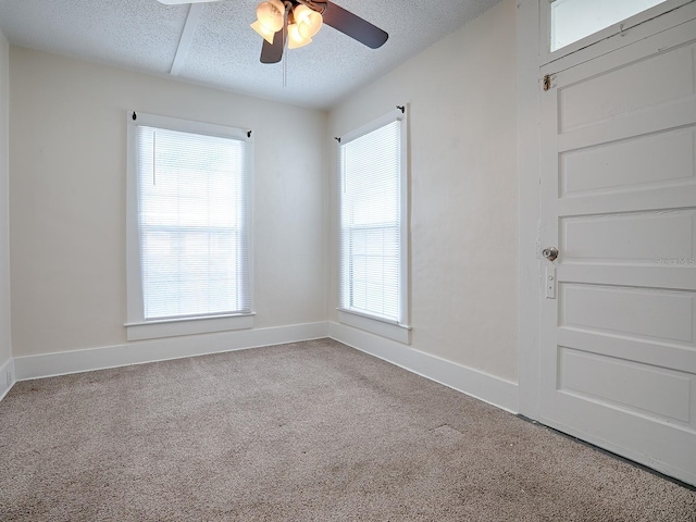 unfurnished room with light carpet, a textured ceiling, and ceiling fan