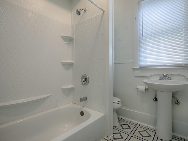 bathroom featuring toilet, tile flooring, and bathing tub / shower combination