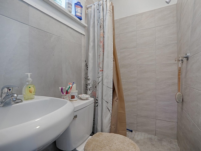 bathroom with walk in shower, toilet, and sink