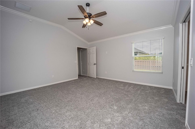 carpeted spare room featuring crown molding, ceiling fan, and vaulted ceiling