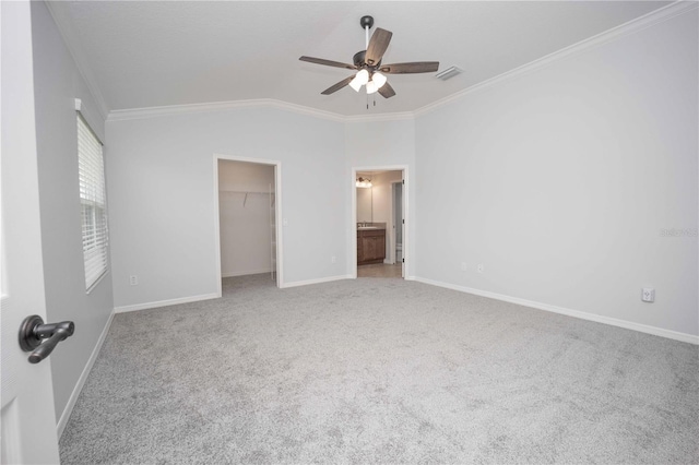 unfurnished bedroom with light carpet, ceiling fan, vaulted ceiling, and ornamental molding