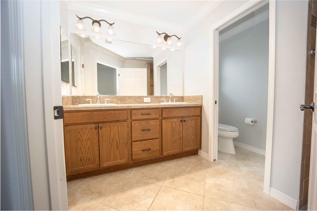 bathroom with dual sinks, toilet, ornamental molding, large vanity, and tile floors